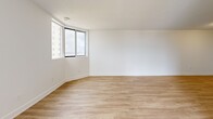 Located at 677 Richmond St in London, Ontario, this 2-bedroom, 2-bathroom unit offers a thoughtfully designed single-floor layout that balances comfort and functionality. Light-toned hardwood flooring runs throughout the space, complementing the crisp white walls and clean-lined finishes that define the unit's modern aesthetic.

The living area is bright and generously proportioned, featuring large windows that invite natural light and offer views of the surrounding cityscape. A private balcony extends the living space outdoors, providing an ideal spot for relaxation.

The primary bedroom is a well-sized retreat featuring built-in closet storage and warm hardwood flooring. The second bedroom is equally well-finished with its own natural light source and access to the hallway.

Both bathrooms are finished to a high standard. The main bathroom features a full soaker tub and shower combination lined with classic white subway tiles, a vanity with a white countertop, and neutral stone-toned tile flooring. The ensuite bathroom offers a glass-enclosed walk-in shower with matching subway tile, a white vanity, and the same refined tile flooring.

A connecting hallway ties the layout together efficiently, contributing to the overall sense of order and ease of movement throughout this polished and move-in-ready unit.