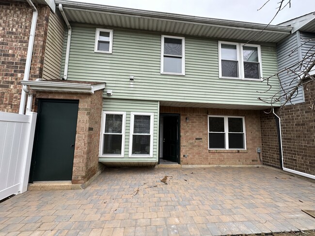 Back of property with storage closet and new patio - 8 Revelle St