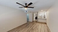 Located at 1350 E Northern Ave in Phoenix, AZ, this single-floor unit offers a clean, modern aesthetic throughout. The open living area is finished with light wood-style luxury vinyl plank flooring and features a stylish dark-bladed ceiling fan with integrated lighting, creating a comfortable and airy atmosphere. Neutral tones on the walls complement the bright, open feel of the space.

The kitchen is thoughtfully designed with gray cabinetry, granite-style countertops, and a peninsula with a built-in sink that doubles as a breakfast bar. Stainless steel appliances, including a refrigerator and electric range, add a contemporary touch, while under-cabinet lighting enhances both function and ambiance.

The bedroom features plush carpeting, a ceiling fan, and a window fitted with blinds that allows natural light to filter in while maintaining privacy. The layout flows naturally from the living area through to the private spaces, with interior doors providing clear separation between rooms.

Overall, the unit presents a refreshed, move-in-ready interior that balances practicality with modern design, making it a well-suited space for comfortable everyday living in the heart of Phoenix.