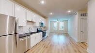 Located at 4710 Old Decatur Rd in Fort Worth, TX, this well-designed one-bedroom, one-bathroom residence offers a thoughtful single-floor layout that maximizes functionality and comfort. Light hardwood-style flooring runs throughout the entire unit, creating a cohesive and clean aesthetic.

The open-concept living area seamlessly connects the kitchen, dining, and living spaces. The kitchen is a standout feature, outfitted with white shaker cabinets reaching to the ceiling, dark granite countertops, a classic white subway tile backsplash, and a full suite of stainless steel appliances including a refrigerator, electric range, microwave, and dishwasher. A dedicated pantry provides additional storage convenience.

The living area is bright and airy, benefiting from natural light through windows fitted with white blinds and a ceiling fan overhead. The bedroom is a comfortable retreat with two windows that invite natural light and offer outdoor views. It includes a spacious walk-in closet with built-in shelving and hanging rods for ample storage.

The bathroom is well-appointed with white shaker cabinetry, dark granite countertops, a subway tile tub-surround, and recessed lighting. Additional practical spaces include a dedicated laundry area and utility room, rounding out this move-in-ready home.