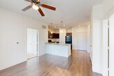 This 780 square foot apartment in Houston, TX offers a well-designed living space with two bedrooms and one bathroom. The primary bedroom, measuring 130 square feet, provides a comfortable retreat. The apartment features a mix of flooring, with plush carpeting in the bedrooms and living areas, and durable wood-look flooring in the kitchen.

The modern kitchen is a highlight, boasting dark wood cabinetry, granite countertops, and black appliances, including a refrigerator, stove, and built-in microwave. A breakfast bar with pendant lighting adds functionality and style.

Large windows throughout the apartment allow for ample natural light, creating a bright and airy atmosphere. Ceiling fans in the bedrooms and living areas provide additional comfort and air circulation.

The bathroom features a tub-shower combination with white tiling, offering a clean and fresh appearance. Storage is well-considered, with two closets in the apartment and wire shelving systems for organization.

The apartment's layout is efficient, with an open-concept design that seamlessly connects the living areas. A notable feature is the French doors in one room, possibly leading to a small balcony or patio, offering a connection to the outdoors.

Overall, this apartment combines modern amenities with a practical layout, making it an ideal choice for those seeking comfortable, efficient living in Houston.