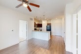This 780 square foot apartment in Houston, TX offers a well-designed living space with two bedrooms and one bathroom. The primary bedroom, measuring 130 square feet, provides a comfortable retreat. The apartment features a mix of flooring, with plush carpeting in the bedrooms and living areas, and durable wood-look flooring in the kitchen.

The modern kitchen is a highlight, boasting dark wood cabinetry, granite countertops, and black appliances, including a refrigerator, stove, and built-in microwave. A breakfast bar with pendant lighting adds functionality and style.

Large windows throughout the apartment allow for ample natural light, creating a bright and airy atmosphere. Ceiling fans in the bedrooms and living areas provide additional comfort and air circulation.

The bathroom features a tub-shower combination with white tiling, offering a clean and fresh appearance. Storage is well-considered, with two closets in the apartment and wire shelving systems for organization.

The apartment's layout is efficient, with an open-concept design that seamlessly connects the living areas. A notable feature is the French doors in one room, possibly leading to a small balcony or patio, offering a connection to the outdoors.

Overall, this apartment combines modern amenities with a practical layout, making it an ideal choice for those seeking comfortable, efficient living in Houston.