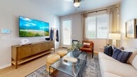 Located in Phoenix, AZ, this single-story, 2-bedroom, 4-bathroom home offers a well-organized layout with a bright, contemporary aesthetic throughout. The open kitchen is equipped with stainless steel appliances, white upper cabinetry, two-tone lower cabinets, crisp white countertops, and a peninsula with bar seating — all complemented by light wood-style flooring and a window that floods the space with natural light. The living room is warm and inviting, featuring a ceiling fan, large windows with blinds, hardwood-style flooring, and direct access to the outdoors. Both bedrooms are accented by calming blue feature walls, generous natural light from well-placed windows, and tasteful finishes. The primary bedroom includes an en-suite bathroom with a walk-in glass-door shower and an adjoining walk-in closet with built-in shelving. A second full bathroom offers a shower-tub combination in a clean, white finish. Additional bathrooms provide practical convenience for guests and residents alike. The home's exterior includes a private outdoor area with lush turf and a landscaped rock garden, offering a peaceful retreat. Light wood-style flooring runs consistently throughout, unifying the home's modern and functional design.