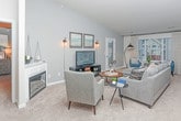 Located at 51061 Mound Rd in Shelby Township, Michigan, this single-floor home offers a well-designed, open-concept layout that balances comfort and functionality throughout. The living room serves as the heart of the home, showcasing vaulted ceilings, soft neutral carpet, and cool gray walls that create a relaxed, welcoming atmosphere. Large windows flood the space with natural light and provide pleasant views of the surrounding neighborhood, while a glass door offers convenient exterior access. The kitchen is equipped with rich dark cabinetry, granite countertops, and black appliances. A wrap-around breakfast bar with seating for three connects the kitchen to the main living area, making it ideal for casual dining and entertaining. An intimate dining area adjacent to the kitchen provides a dedicated space for formal meals. The primary bedroom is generously proportioned with vaulted ceilings, wide windows, plush carpeting, and a walk-in closet. Its en-suite bathroom features dark wood cabinetry, granite countertops, and a clean, tile-accented design. A dedicated laundry room with side-by-side washer and dryer and durable hardwood-style flooring adds everyday practicality to the home. Throughout, consistent finishes and thoughtful detailing contribute to a cohesive and polished living experience.