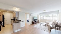 Located at 3201 Wisconsin Ave NW, Unit 402 in Washington, DC, this one-bedroom, one-bathroom residence offers a well-designed layout across a single floor. Light wood flooring flows throughout the main living areas, creating a warm and cohesive aesthetic.

The living room is bright and welcoming, featuring wide windows that invite natural light and offer views of the surrounding neighborhood. A wall-mounted mini-split system provides climate control, and the open sightlines to the kitchen enhance the sense of space.

The kitchen is a functional galley-style space appointed with light wood cabinetry, dark granite countertops, stainless steel appliances including a refrigerator and dishwasher, and clean tile flooring. Ample cabinet storage lines both sides of the kitchen for efficient use of the layout.

The bedroom is a comfortable and serene retreat, highlighted by a large window with neighborhood views and light wood flooring. The room offers generous space for furnishings and easy access to the bathroom.

The bathroom features a clean, classic design with white tile surrounding a tub-shower combination, a white vanity with a gold-toned faucet, and a large mirror. The overall ambiance of the unit is bright, neutral, and move-in ready, making it a practical and attractive home in the heart of Washington, DC.