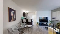 Located in Boca Raton, FL, this one-bedroom, one-bathroom apartment offers a well-designed layout that maximizes its compact footprint. The open-concept living and dining area is anchored by warm wood-style flooring that extends throughout the unit, creating a cohesive and inviting atmosphere. The living room features a neutral accent wall and large windows dressed with vertical blinds, allowing natural light to fill the space. A defined dining area comfortably accommodates a glass-top table, while the adjacent kitchen is outfitted with rich dark-espresso cabinetry, white countertops, a mosaic tile backsplash, stainless steel appliances, and a breakfast bar with seating — ideal for casual dining. A hallway connects the living areas to the private quarters of the unit. The generously sized bedroom features a wide mirrored sliding-door closet that enhances the sense of space, a large window with garden views, and enough room for both sleeping and a dedicated workspace. The bathroom includes a full tub-shower combination with tile surround, a vanity with dark cabinetry, and wood-style flooring that ties the space together. Two hallways provide functional transitions throughout the unit, completing this efficiently planned Boca Raton residence.
