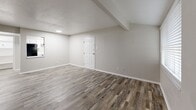 Located at 3523 Fawn Valley Dr in Dallas, TX, this single-floor, 3-bedroom, 2-bathroom home offers a practical and well-organized layout. Throughout the home, warm-toned, wood-look luxury vinyl plank flooring creates a cohesive and modern aesthetic, complemented by neutral gray walls and clean white trim and doors.

The living area provides an open, airy feel with natural light filtering through windows fitted with horizontal blinds. Exposed beam-style details add a subtle architectural character to the space.

Each of the three bedrooms features the same consistent flooring and neutral palette. The primary bedroom offers a comfortable footprint with windows that bring in natural light. Two of the bedrooms include closets — one with a double sliding-door closet — providing ample storage. The third bedroom also benefits from natural light through a well-positioned window.

The two bathrooms are cleanly finished. One features a white vanity with a granite-style countertop, a tiled tub-shower combo with chrome fixtures, and wood-look flooring. The second bathroom is similarly appointed with chrome towel bars and a toilet, maintaining a consistent, tidy finish throughout.

The home also includes two closets for additional storage, rounding out a functional and move-in-ready residence in Dallas, TX.