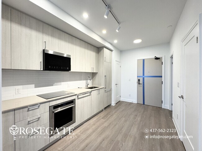 Photo du bâtiment - Modern 1 Bedroom + Den (Potential 2nd Bedroom) Condo with Parking & Balcony