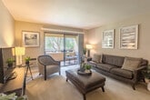 Located at 2079 McLaughlin Ave in San Jose, CA, this well-designed 2-bedroom, 2-bathroom single-floor residence offers a functional and comfortable layout. The living room serves as the heart of the home, featuring soft neutral tones, light wood flooring, and a sliding glass door that opens to an enclosed balcony — a private outdoor retreat surrounded by greenery. The galley-style kitchen is efficiently arranged with white cabinetry, ample counter space, a double sink, and white appliances, offering a clean and organized cooking environment. Adjacent to the kitchen, the dedicated dining room provides a defined space for meals, complete with a ceiling fan overhead. A connecting hallway with wood-look flooring guides residents between the common areas and the private quarters. The primary bedroom is generously proportioned, featuring plush carpeting, a large built-in sliding-door closet with shelving, and access to natural light. The second bedroom also offers open closet storage and carpeted flooring. Both bathrooms are clean and functional, with one featuring a tub-shower combination. The home's consistent neutral palette and thoughtful layout make it a practical and inviting residence in the heart of San Jose.