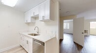 Located at 750 S Carondelet St in Los Angeles, this single-story, one-bedroom, one-bathroom residence offers a thoughtfully designed layout with clean, modern finishes throughout. Light wood-tone flooring flows consistently across all rooms, creating a cohesive and airy aesthetic.

The living room is generously proportioned, featuring crisp white walls, a stylish gold-accented ceiling fan, a wall-mounted HVAC unit, and a sliding glass door that invites natural light and provides outdoor access. The kitchen is outfitted with white shaker-style cabinetry, brushed nickel hardware, quartz countertops with a marble-like finish, a stainless steel single-basin sink, and a stainless steel dishwasher—offering a clean, contemporary look.

The bedroom provides a comfortable retreat with a large window that brings in natural light and an urban view, along with a dedicated closet featuring a built-in hanging rod and shelf for organized storage. The bathroom is finished in an all-white palette, equipped with a full tub-shower combination with built-in shelving, and complemented by wood-look flooring that ties the space together.

Overall, the unit presents a well-maintained, move-in-ready interior with a bright and neutral design that is both practical and welcoming.