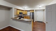 Located at 9 Winthrop St in Rochester, NY, this two-floor residence offers a well-organized and functional layout across both levels. The main floor greets you with rich, dark hardwood flooring that extends throughout the open living and dining areas. A striking bay window arrangement floods the living space with natural light, while a pass-through peninsula connects seamlessly to the kitchen. The kitchen is well-appointed with warm honey-toned cabinetry, granite-style countertops, stainless steel appliances including a refrigerator, range, and microwave, and a stainless steel sink — all complemented by the continuity of hardwood flooring. A dedicated entry door with sidelight provides a welcoming arrival point on this level. Upstairs, the bedrooms are finished with plush carpeting and feature windows that bring in ample natural light. Each room offers a comfortable and versatile layout. A full bathroom on the upper level is equipped with granite-topped vanity cabinetry and brushed nickel fixtures, including a towel ring, towel bar, and toilet paper holder. A convenient stacked washer and dryer unit is also located on the upper floor, adding practical in-unit laundry access. Neutral wall tones throughout create a clean, move-in-ready atmosphere.