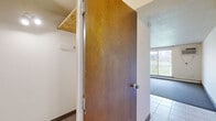 Located at 401 Chicago Ave in Minneapolis, MN, this 2-bedroom, 1-bathroom unit offers a practical and functional layout across a single floor. The living room is a spacious, open area featuring neutral carpet, a textured ceiling, and track lighting that brightens the room. It flows seamlessly into the kitchen, which is finished with light tile flooring and includes standard appliances such as a white range and refrigerator, along with wood-toned cabinetry.

The primary bedroom is generously sized and features a sliding glass door that opens to an outdoor view, filling the room with natural light. A wall-mounted air conditioning unit and baseboard heating provide year-round climate control. The second bedroom is bright and well-proportioned, with a large window offering additional outdoor views and baseboard heating along the wall.

Both bedrooms are carpeted, and the primary bedroom includes access to a dedicated closet. The full bathroom is straightforward and clean, featuring a tiled tub and shower surround with a curtain enclosure. A hallway connects the rooms efficiently, and an entrance area provides a clear transition into the unit. The overall design is clean and neutral, offering a practical living environment in the heart of Minneapolis.