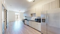 Located at 1104 Via Corso Ave in Mauldin, SC, this 2-bedroom, 2-bathroom residence offers a thoughtfully designed open-concept layout with contemporary finishes throughout. Light wood-style flooring flows seamlessly across the entire living space, creating a clean and cohesive aesthetic.

The kitchen is a standout feature, showcasing light wood cabinetry extending to the ceiling, a classic white subway tile backsplash, dark countertops, and a full suite of stainless steel appliances including a range, dishwasher, microwave, and refrigerator. The kitchen opens directly into a spacious living area bathed in natural light, with access to a glazed entry door.

Both bedrooms are well-proportioned, each featuring large windows that bring in abundant natural light and offer exterior views. Ceiling fans add comfort, and each bedroom benefits from its own dedicated closet with wire shelving systems for organized storage.

The two bathrooms are finished with neutral stone-look tile flooring. One bathroom features a tub-shower combination and bold dark-paneled door accents, while the second includes a vanity with granite-style countertops and a tub-shower unit. The clean, neutral color palette throughout the home creates a bright and welcoming ambiance well-suited for modern living.