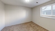 Located at 2707 S Emporia St in Wichita, Kansas, this one-bedroom, one-bathroom unit offers a practical and efficiently designed single-floor layout. The galley-style kitchen is a standout feature, equipped with warm oak cabinetry on both sides, white appliances including a refrigerator and range, a double-basin sink, and light-toned countertops. Tile flooring runs throughout the kitchen, adding durability to a functional cooking space. A peninsula with additional cabinet storage bridges the kitchen to the living area, which features neutral carpet underfoot and a textured ceiling overhead. The bedroom is a comfortable, carpeted retreat enhanced by natural light from a window with blinds. It offers generous storage through two louvered bi-fold closet doors, providing ample wardrobe space. The full bathroom includes a tub and shower combination with clean white surround panels, chrome fixtures, a grab bar, and overhead cabinetry for added storage. Throughout the unit, neutral white walls, textured ceilings, and consistent carpeting in the main living areas create a cohesive and low-maintenance living environment. This unit provides a straightforward, functional layout well-suited for comfortable everyday living.
