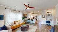 This single-story home on Blue Mound Lane in Huntsville, Alabama offers a well-designed open-concept floor plan that seamlessly connects the living, dining, and kitchen areas. Crown molding, wood-look plank flooring, and neutral tones create a cohesive aesthetic throughout the common spaces.

The living area is bright and welcoming, featuring large windows with white blinds and sheer curtains that allow generous natural light, complemented by a ceiling fan overhead. The space flows directly into the kitchen, which is outfitted with white shaker-style cabinetry, granite countertops, a subway tile backsplash, and a full suite of stainless steel appliances. A peninsula with bar seating and pendant lighting adds both functionality and visual appeal.

The bedrooms are comfortably sized, each featuring crown molding, ceiling fans, and windows that bring in natural light. The bathroom includes a granite-topped vanity with white cabinetry, a tub-shower combination, and oil-rubbed bronze fixtures that add a refined touch.

Overall, the home presents a clean, modern interior with consistent finishes and a practical layout suited for everyday living.