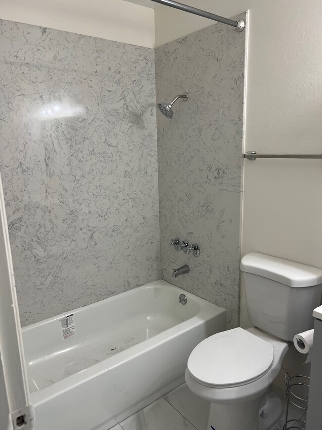 Updated bathroom_ granite tub enclosure - River Park Vista Apartments