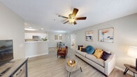 This single-story 2-bedroom, 2-bathroom residence in Mobile, Alabama offers a thoughtfully designed open floor plan that maximizes comfort and functionality. The welcoming entryway features a clean hallway with light wood-style flooring that flows throughout the main living areas.

The spacious living room serves as the heart of the home, highlighted by a ceiling fan, textured ceilings, and French doors that invite natural light and provide outdoor access. The space connects seamlessly to a dedicated dining area, which features a pendant light fixture and ample room for a full dining table.

The galley-style kitchen is well-equipped with white cabinetry, brushed nickel hardware, white countertops, a stainless steel refrigerator, and a full appliance suite — all complemented by the same wood-style flooring found throughout the main areas.

Both bedrooms are carpeted for added comfort and include ceiling fans and natural light from well-positioned windows. Closet space is provided in each room for convenient storage. The two bathrooms are finished with wood-style flooring, white vanities with light countertops, and a tub/shower combination with brushed nickel fixtures.

Throughout the home, a neutral warm-beige color palette and consistent finishes create a cohesive, move-in-ready atmosphere well-suited for everyday living in Mobile, AL.