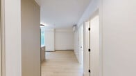 Located in the vibrant Bankview neighbourhood of Calgary, this thoughtfully designed 2-bedroom, 2-bathroom unit offers a clean, contemporary aesthetic throughout. The open-concept kitchen and living area serves as the heart of the home, featuring light wood cabinetry with matte black hardware, white quartz countertops, a decorative stone tile backsplash, stainless steel appliances, and a central island that provides additional prep and dining space. Light hardwood flooring flows seamlessly throughout, enhancing the bright and airy atmosphere. Both bedrooms are finished with crisp white walls and windows that bring in natural light and views of the surrounding tree-lined streetscape. Each of the two bathrooms is outfitted with large-format tile, a soaker tub with a frameless sliding glass enclosure featuring sleek black fixtures, and a vanity with undermount sink and wood cabinetry. In-unit laundry is conveniently included with a stacked Samsung washer and dryer. A private balcony extends the living space outdoors, offering pleasant views of the mature trees and neighbourhood below. The overall design is cohesive and modern, with a neutral palette that creates a calm, functional living environment.
