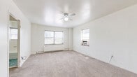 Located at 817 Pennsylvania Ave in Kansas City, MO, this efficiently designed unit offers a well-organized layout comprising a living room, kitchen, full bathroom, and two closets. The living area is finished with neutral wall-to-wall carpeting and features a ceiling fan with light fixture, providing both comfort and airflow. Two windows allow natural light to fill the room, while a baseboard radiator and a window-mounted air conditioning unit ensure year-round climate control. The kitchen is compact yet functional, equipped with a gas range, white cabinetry, a speckled laminate countertop, and a stainless steel sink — offering the essentials for everyday meal preparation. The bathroom is finished in classic white ceramic tile, featuring a soaking tub with a combination tub/shower, a wall-mounted sink with chrome fixtures, and a window with a privacy blind that brings in natural light. Two closets provide practical storage options within the unit. The clean, white walls and simple finishes throughout create a bright and neutral palette, making the space easy to personalize. Situated in the heart of Kansas City's historic River Market area, this unit offers convenient access to local amenities and urban attractions.