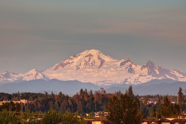 Snow-capped Mount Baker rising over the Fraser Valley at sunset.