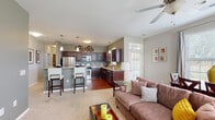 Located at 9123 Cleveland St in Merrillville, Indiana, this single-floor residence offers a thoughtfully designed open-concept layout that seamlessly connects the kitchen and living area. The kitchen is a standout feature, boasting rich dark cabinetry, granite countertops, a granite-topped breakfast bar with seating, stainless steel appliances including a refrigerator, microwave, gas range, and dishwasher, and warm hardwood flooring. Pendant lighting and decorative wall accents add a stylish touch overhead. The living area flows naturally from the kitchen, featuring plush carpeting, a ceiling fan, and multiple windows fitted with blinds that allow for ample natural light. The bedroom is a serene retreat with soft carpet, a calming blue accent wall, a ceiling fan, and a large window overlooking greenery, complemented by a spacious closet. The bathroom features tile flooring, a granite vanity with dark wood cabinetry, a framed mirror, and a tub-shower combination. A dedicated laundry room with full-size washer and dryer hookups and tile flooring adds everyday convenience. Throughout the residence, neutral tones and consistent finishes create a cohesive and inviting atmosphere.