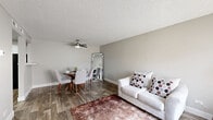 Located at 12185 Albrook Dr in Denver, CO, this 2-bedroom, 1-bathroom home offers a functional and thoughtfully designed single-floor layout. The open living and dining area is highlighted by wood-style plank flooring, a ceiling fan, and a textured ceiling, creating a warm and inviting atmosphere. Natural light filters in through window blinds, brightening the neutral gray walls throughout. A pass-through window connects the kitchen to the living area, enhancing the sense of openness. The kitchen features crisp white cabinetry, light granite-style countertops, black appliances including a range and dishwasher, and a stainless steel sink — offering both style and practicality. A hallway leads to the two bedrooms, each carpeted for comfort. The primary bedroom includes a window with natural light and ample space, while the second bedroom also features carpeting and a window. Two closets provide generous storage. The full bathroom is finished with white subway tile in the tub-shower surround, accented by a decorative mosaic tile border, and wood-style flooring. This home offers a clean, move-in-ready aesthetic with consistent finishes throughout.