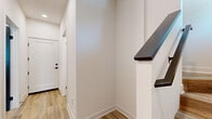 Located in Fontana, CA, this two-story, 2-bedroom, 2-bathroom home offers a clean, modern aesthetic throughout. The main floor houses the living room and a well-appointed kitchen featuring dark gray shaker-style cabinetry, a white quartz waterfall island with an undermount sink, a subway tile backsplash, stainless steel appliances, and sleek pendant lighting — making it a functional and visually striking centerpiece of the home. Light wood-look flooring runs throughout, complementing the crisp white walls and contemporary black hardware accents.

Upstairs, the two bedrooms offer comfortable retreats, each with sliding closet doors and recessed lighting. The generously sized primary bedroom includes a dedicated closet and is served by a private en-suite bathroom featuring a walk-in tiled shower, gray vanity with white countertop, and wood-look flooring. The second bathroom includes a full tub-shower combination with sliding glass doors and matching modern finishes.

The staircase, lined with a dark wood handrail against white walls, connects the two levels with a clean, contemporary transition. Throughout the home, the consistent use of neutral tones, modern fixtures, and quality materials creates a cohesive and move-in-ready living environment.