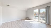 Located at 532 W Brookhaven Road in Brookhaven, Pennsylvania, this single-floor, one-bedroom unit offers a clean, modern aesthetic throughout. Light gray wood-style flooring runs consistently across all rooms, creating a cohesive and bright interior that reflects natural light effectively.

The living area is generously proportioned, featuring crisp white walls, multiple HVAC vents for year-round comfort, and a sliding glass door that opens to a private balcony overlooking a tree-lined outdoor setting. This connection to the outdoors adds both natural light and a pleasant sense of openness to the main living space.

The kitchen is well-equipped with warm-toned wood cabinetry, granite-look countertops, and a full suite of white appliances including a gas range, over-the-range microwave, and dishwasher. A functional layout allows for efficient use of the space.

The bedroom is a comfortable, well-lit room with a large closet offering built-in shelving and hanging storage. Natural light filters in through a window with an exterior view, and the neutral palette keeps the room feeling open and airy.

Additional spaces include a secondary room suitable for various uses, complete with its own closet, as well as a connected hallway that ties the layout together seamlessly. The unit presents a well-maintained, move-in-ready condition throughout.