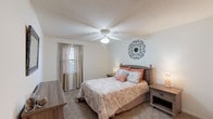 Located at 502 Michael St in Kernersville, North Carolina, this single-floor home offers a well-organized layout designed for comfortable everyday living. The living room provides a welcoming gathering space with plush carpet flooring, natural light from a curtained window, and a textured ceiling overhead. The kitchen is outfitted with rich dark cabinetry, black countertops, wood-look flooring, and includes a range, dishwasher, and ample storage — making it both practical and visually striking. The home features multiple carpeted bedrooms, each thoughtfully sized to accommodate full bedroom sets. One bedroom includes a ceiling fan with light fixture and window with natural light, while another features access to a walk-in closet, adding valuable storage. The bathrooms are finished with dark wood vanities, dark countertops, and wood-look flooring; one includes a shower/tub combination and the other a walk-in shower, both clean and functional in design. Throughout the home, the neutral color palette and consistent finishes create a cohesive and inviting atmosphere. The floorplan, as visible in the dollhouse view, reflects an efficient use of space across its single level, connecting all areas in a practical and accessible flow.