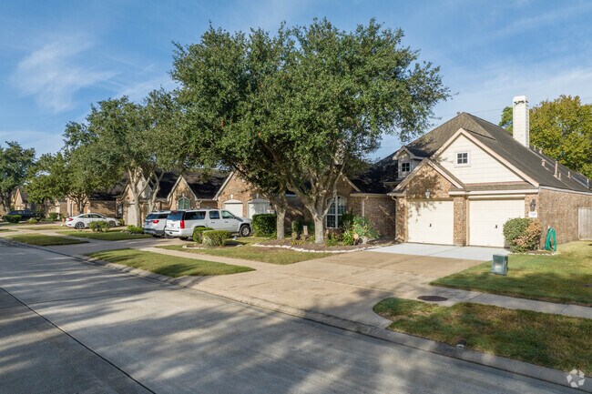 A row of homes sit underneath mature oak trees in Westland Ranch.