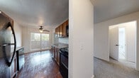 Located at 2017 E Henrietta Rd in Rochester, NY, this 2-bedroom, 1-bathroom residence offers a practical and comfortable single-floor layout. The combined kitchen and dining area is a functional centerpiece, featuring warm wood cabinetry, granite-style countertops, black appliances including a range, dishwasher, and refrigerator, and rich hardwood flooring. A ceiling fan with light fixture and a sliding glass door bring in natural light and provide outdoor access, while a white-painted brick accent wall adds character. The living room continues the carpeted flooring theme and connects smoothly to the rest of the home. Both bedrooms are carpeted and generously sized, with the primary bedroom offering notable space. One bedroom showcases a distinctive white-painted brick wall and a sliding closet, while the other features clean white walls and a hallway closet nearby. In total, four closets are distributed throughout the home, providing ample storage. The bathroom is bright and clean, complete with a tub-shower combo, a vanity with under-sink storage, a medicine cabinet mirror, and tile flooring. Two hallways connect the rooms efficiently, rounding out this well-organized and functional home.