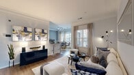 Located at 12175 Lincoln Lake Way in Fairfax, Virginia, this single-floor residence offers a thoughtfully designed layout with a cohesive blend of modern finishes and comfortable living spaces. Crown molding and wood-style flooring carry throughout the main living areas, contributing to a polished, unified aesthetic.

The open-concept living and dining area is anchored by large windows dressed with layered Roman shades and floor-length drapes, allowing generous natural light to fill the space. A dedicated dining nook features its own set of oversized windows and a glass-panel door, creating a bright, airy setting. The living room offers ample room for seating arrangements and connects seamlessly to the rest of the main area.

The kitchen is equipped with rich dark-espresso cabinetry, granite-style countertops, stainless steel appliances including a range, microwave, and refrigerator, and hardwood-style flooring, combining functionality with contemporary style.

The bedroom is generously sized with plush carpeting, a textured accent wall, and direct access to a spacious walk-in closet outfitted with wire shelving. The bathroom features dark vanity cabinetry, white countertops, a tub-shower combination, and wood-style flooring. A dedicated in-unit laundry area with full-size washer and dryer adds everyday convenience.