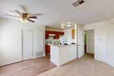 Located at 6001 Auburn St in Bakersfield, CA, this one-bedroom, one-bathroom single-floor residence offers a well-organized and functional layout across a comfortable footprint. The open-concept living area flows seamlessly into the combined kitchen and dining space, creating a connected and practical environment for everyday living. The kitchen is equipped with warm wood-toned cabinetry, a coil electric range, refrigerator, dishwasher, and a double stainless steel sink, all set atop durable wood-style flooring. A peninsula counter serves as a natural divider between the kitchen and the adjacent living area, which features a ceiling fan with light fixture and a textured ceiling. The living area transitions into carpeted flooring, adding warmth and comfort underfoot. The bedroom is a generously proportioned, bright room with plush carpeting, neutral white walls, and a window that allows natural light to filter in. Two closets provide ample storage throughout the unit. The bathroom includes a full soaking tub with a clean, tiled surround. A private balcony offers an additional outdoor retreat. The overall design is clean and neutral, providing a versatile canvas well-suited for a variety of living arrangements.