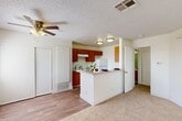 Located at 6001 Auburn St in Bakersfield, CA, this one-bedroom, one-bathroom single-floor residence offers a well-organized and functional layout across a comfortable footprint. The open-concept living area flows seamlessly into the combined kitchen and dining space, creating a connected and practical environment for everyday living. The kitchen is equipped with warm wood-toned cabinetry, a coil electric range, refrigerator, dishwasher, and a double stainless steel sink, all set atop durable wood-style flooring. A peninsula counter serves as a natural divider between the kitchen and the adjacent living area, which features a ceiling fan with light fixture and a textured ceiling. The living area transitions into carpeted flooring, adding warmth and comfort underfoot. The bedroom is a generously proportioned, bright room with plush carpeting, neutral white walls, and a window that allows natural light to filter in. Two closets provide ample storage throughout the unit. The bathroom includes a full soaking tub with a clean, tiled surround. A private balcony offers an additional outdoor retreat. The overall design is clean and neutral, providing a versatile canvas well-suited for a variety of living arrangements.