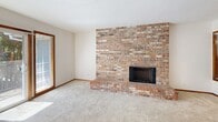 Located in Beaverton, Oregon, this single-floor, 2-bedroom, 3-bathroom home offers a well-organized layout with consistent warm-toned finishes throughout. The living room serves as a central gathering space, anchored by a full-height brick fireplace that adds a classic, rustic character. Sliding glass doors with wood trim frame access to a private balcony, flooding the space with natural light and providing outdoor views of surrounding greenery.

The kitchen is thoughtfully designed with rich wood cabinetry, light-toned countertops, tile flooring, and a central island that provides added workspace and storage. A dedicated pantry closet with open shelving sits just off the kitchen, offering practical storage capacity. The electric range and dishwasher are included among the kitchen's fixtures.

Both bedrooms are carpeted and feature wood-framed windows that bring in natural light. The primary bedroom offers a comfortable footprint, while baseboard heating ensures year-round comfort. Wood-trimmed doors are consistent throughout.

The three bathrooms include tile flooring and wood cabinetry with light countertops. One bathroom features a tub-shower combination with white tile surround, while another includes a separate toilet room for added privacy. Warm wood accents carry through the bathrooms, maintaining design cohesion across the entire home.
