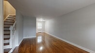 Located at 536 Alden Dr in Rahway, NJ, this two-bedroom, one-bathroom home spans three floors, offering a well-structured layout with dedicated spaces for living, dining, and storage. The main living level features a spacious living room and adjoining dining area, both showcasing richly polished hardwood floors that run throughout the home. Neutral gray walls and classic white trim create a clean, understated aesthetic. A staircase with a white-painted balustrade connects the floors with traditional charm. The kitchen is equipped with warm-toned wood cabinetry, granite-style countertops, a gas range, and a double sink beneath a natural light-admitting window. Upstairs, two bedrooms offer generous proportions, with the primary bedroom providing a comfortable retreat. Both rooms continue the hardwood flooring and feature radiator heating units. Four closets distributed across the home ensure ample storage. The full bathroom includes a tiled tub-shower combo, a window for ventilation, and tile flooring. The unfinished basement provides additional storage or utility space with a painted concrete floor and exposed ceiling joists. The exterior reflects classic brick construction with a welcoming front entry.