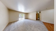 Located at 13510 N Creek Dr in Mill Creek, WA, this single-floor residence offers four bedrooms, two full bathrooms, and a practical, well-organized layout. The living room is bright and welcoming, featuring soft carpeting and sliding glass doors that open to a private balcony with views of surrounding greenery — an ideal space for relaxing or entertaining. The adjacent kitchen is equipped with light wood cabinetry, dark granite-style countertops, wood-look flooring, and a full-size refrigerator, providing ample storage and prep space. The primary bedroom is a comfortable retreat with direct access to one of the two bathrooms, which features a wide vanity with dark countertops, light wood cabinetry, a large mirror, and a full bathtub with shower. The additional bedrooms are carpeted and receive natural light through windows that frame views of the lush Pacific Northwest landscape, with one bedroom also offering a closet. A second full bathroom includes a tub/shower combination. Throughout the home, neutral tones, plush carpeting in living areas, and wood-look flooring in wet areas create a clean, cohesive aesthetic. Two closets provide dedicated storage solutions across the floor plan.