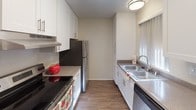 Located at 3511–3549 Valley Rd in Bonita, this single-floor unit offers a well-designed layout with a variety of functional spaces. The living area is bright and open, featuring durable wood-style flooring, crown molding, a ceiling fan with light fixture, and a wall-mounted air conditioning unit. Large vertical-blind-covered windows and a sliding glass door flood the room with natural light and provide direct access to an outdoor patio area, offering views of surrounding greenery.

An open pass-through connects the living area to the dining space and galley-style kitchen, which is outfitted with white cabinetry, granite-style countertops, a stainless steel double sink, dishwasher, electric range, and a full-size refrigerator. Ample upper and lower cabinet storage makes the kitchen both practical and visually clean.

The bedroom is generously sized with plush carpeting, a textured ceiling, and multiple windows dressed with vertical blinds that invite natural light throughout the day.

The bathroom is neatly appointed with wood-style flooring, a single-sink vanity with granite-style countertop, white cabinetry, a large mirror, and a combined tub and shower. The layout is efficient and well-lit. Overall, this unit presents a clean, functional, and comfortable living environment in Bonita.