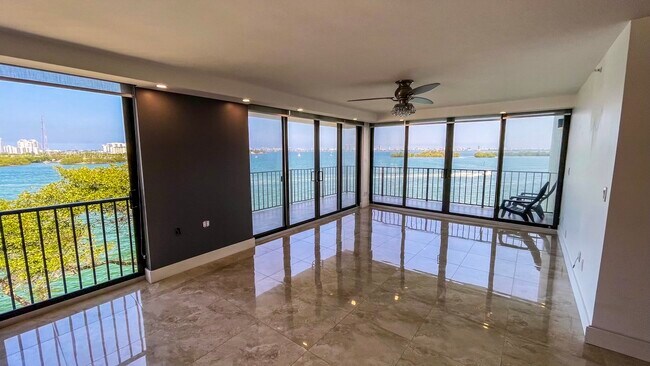 Spacious Living room has wrap around terrace with 180 degree views of Sunny Isles to Downtown Miami - 7751 NE Bayshore Ct