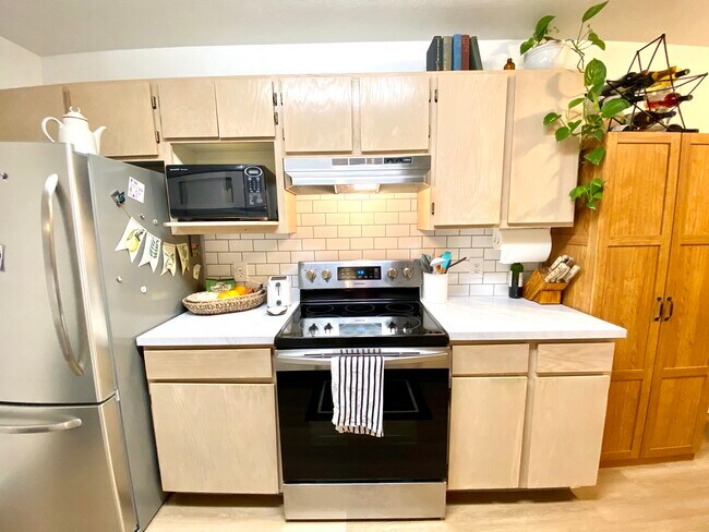 Kitchen with off counter microwave. - 135 Baker Street #102