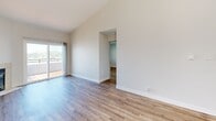 Located at 1107 Porter Street in Vallejo, CA, this single-floor, 2-bedroom, 2-bathroom home offers a clean and functional layout designed for comfortable living. The open living and dining area is immediately welcoming, featuring soaring vaulted ceilings that lend a sense of spaciousness, warm hardwood-style flooring throughout, and a tile-surround fireplace that serves as a natural focal point. Natural light flows in through sizable windows fitted with blinds, and a sliding glass door opens to a private balcony with outdoor views.

The kitchen is equipped with dark taupe cabinetry, a stainless steel refrigerator, an electric range, and a broad white countertop peninsula that connects seamlessly to the living and dining area — ideal for casual dining or entertaining. A window above the sink adds natural light.

Both bedrooms are well-proportioned with hardwood-style flooring and windows for natural light. The primary bedroom includes a mirrored sliding-door closet, maximizing both storage and the sense of space. The home includes four closets in total for ample storage. Both bathrooms feature tub-shower combinations with clean white surrounds, vanities, and hardwood-style flooring. An in-unit laundry area and a hallway complete this efficiently organized home.