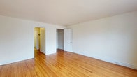 Located at 117 North Essex Avenue in the charming borough of Narberth, Pennsylvania, this single-floor space offers a straightforward and functional layout with timeless design details. The interior is defined by warm-toned hardwood flooring that runs throughout, lending the space a classic and inviting character. Crisp white walls and ceilings enhance the sense of openness, reflecting light to create a bright and airy atmosphere throughout. The main living area is generously proportioned, providing ample room for a variety of furniture arrangements. A built-in closet offers practical storage solutions, keeping the space organized and uncluttered. Doorways connect to additional rooms and hallways, suggesting a well-considered flow between spaces. Clean white baseboards frame the floors throughout, adding a polished finishing touch to the overall aesthetic. The space benefits from its location in Narberth, a walkable and vibrant community on the Main Line known for its local shops, dining, and convenient access to public transit. Overall, the space presents a clean, well-maintained interior with enduring materials and a neutral palette that offers a versatile foundation for personalization.