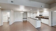 Located at 2627 Ashlan Ave in Clovis, California, this single-story 2-bedroom, 2-bathroom home offers a thoughtfully designed floor plan that maximizes comfort and functionality. The heart of the home is an open-concept living, dining, and kitchen area bathed in a clean, neutral palette. The living room features warm wood-look flooring, a ceiling fan with light fixture, and vaulted ceilings that lend a sense of spaciousness. A peninsula kitchen anchors the space with crisp white cabinetry, dark granite countertops, stainless steel appliances including a gas range and microwave, and recessed lighting overhead. A pendant chandelier adds a refined touch above the dining area. A pantry provides additional storage convenience. The primary bedroom is generously sized, offering a ceiling fan, wood-look flooring, and a large window that invites natural light and outdoor views. The second bedroom features plush carpet flooring. Both bathrooms are finished with dark granite vanity tops. The primary bath includes a tub-shower combo with glass sliding doors. Additional highlights include a dedicated laundry area, multiple closets, a patio, and an attached garage with an automatic opener and concrete flooring — offering ample utility and storage.