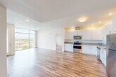This well-appointed 2-bedroom, 3-bathroom residence at 1060 Village Dr in Santa Maria, California, offers a clean, modern aesthetic defined by bright white walls, wood-look flooring, and an abundance of natural light. The open-concept living and kitchen area serves as the heart of the home, where floor-to-ceiling windows frame sweeping views of the surrounding neighborhood and hills, filling the space with natural light. A private balcony door provides direct outdoor access from the living area.

The kitchen is thoughtfully designed with white shaker-style cabinetry, granite countertops, a full suite of stainless steel appliances including a range, microwave, dishwasher, and refrigerator, and recessed lighting overhead.

Both bedrooms are comfortably sized, with the primary bedroom offering generous proportions, large windows with blinds, and wood-look flooring. The three bathrooms are finished with granite-topped white vanities and wood-look flooring, with at least one bathroom featuring an elegant tub-shower combination adorned with marble-style surround tile and chrome fixtures. A dedicated closet adds practical storage. The overall ambiance is contemporary, clean, and move-in ready.