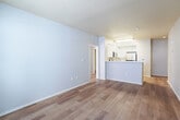 This 560 square foot apartment in Berkeley, CA offers a thoughtfully designed living space. The single-floor layout comprises one bedroom, one bathroom, and an open-concept kitchen and living area. The primary bedroom, measuring 180 square feet, provides ample space for rest and relaxation.

Throughout the apartment, warm wood flooring adds a touch of elegance and continuity. Large windows, including a sliding glass door, flood the space with natural light, creating an airy and inviting atmosphere. The neutral color palette of white walls and ceilings contributes to the bright, clean aesthetic.

The kitchen boasts modern white cabinetry, stainless steel appliances, and a functional island that doubles as a breakfast bar. This open layout seamlessly integrates with the living area, ideal for entertaining or everyday living. The bathroom features a full-sized bathtub with a shower, a sleek vanity, and classic white fixtures.

Built-in closets provide essential storage space, while the overall design maximizes functionality in a compact footprint. Located at 2022 Kittredge Street, this apartment offers contemporary urban living in the heart of Berkeley.