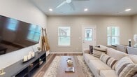 Located at 693 Morsani Pl in Tontitown, Arkansas, this well-designed single-story home offers 2 bedrooms, 2 bathrooms, a dedicated office, and an attached garage. Warm hardwood-style flooring flows throughout, complemented by neutral wall tones and recessed lighting that create a bright, cohesive atmosphere.

The open-concept kitchen and living area serves as the heart of the home. The kitchen is outfitted with crisp white shaker cabinets, quartz countertops, stainless steel appliances, and a central island — ideal for both meal prep and casual dining. The adjacent living room provides a comfortable gathering space with a ceiling fan and ample room for furnishings.

The spacious primary bedroom features a ceiling fan, hardwood-style flooring, and direct access to a walk-in closet with full built-in shelving and hanging rods, as well as a private en-suite bathroom. The en-suite includes a walk-in shower finished with elegant marble-look tile surround. The second bedroom is well-proportioned with a ceiling fan and double-door closet. A dedicated office space offers flexibility for remote work or study.

Additional highlights include a dedicated laundry room with upper cabinetry, a hallway connecting the private quarters, and an attached garage with interior access — providing convenient, practical living throughout.