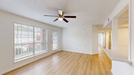 Located at 33 Constellation Cir in Jackson, Tennessee, this well-appointed 2-bedroom, 2-bathroom residence offers a clean, modern aesthetic throughout its single-floor layout. Light hardwood-style flooring runs continuously through the living areas and bedrooms, creating a bright and cohesive feel. The open kitchen is outfitted with white shaker cabinetry, subway tile backsplash, white quartz-style countertops, and stainless steel appliances including a dishwasher and refrigerator. The adjacent living room is generously sized, featuring a ceiling fan with light fixture and large windows with blinds that allow abundant natural light, along with a glass door providing direct outdoor access. Both bedrooms are comfortably proportioned, each with ceiling fans and windows overlooking the outdoors. The primary bedroom offers a notably spacious footprint. Both bathrooms are finished with clean white tub-shower combinations and chrome fixtures. A dedicated laundry room houses a full-size GE washer and dryer with overhead shelving, adding practical convenience. The layout also includes a hallway, two closets, and excellent overall storage. The home presents a fresh, neutral palette throughout, making it move-in ready.