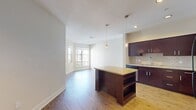 This contemporary 570 square foot apartment in Mission Viejo offers a thoughtful blend of style and functionality. The open-concept design seamlessly integrates the kitchen, living, and dining areas, creating a spacious feel within the compact layout. The kitchen is a standout feature, boasting dark wood cabinetry, stainless steel appliances, and a central island with pendant lighting, perfect for casual dining or food preparation.

The living area is bathed in natural light, thanks to large windows that offer views of the surrounding community. Warm wood-look flooring throughout adds a touch of elegance and continuity. The bedroom, measuring 130 square feet, features plush carpeting and ample closet space, ensuring comfort and storage.

The bathroom is well-appointed with a modern vanity, granite countertop, and a combination tub-shower. Additional amenities include recessed lighting, window treatments for privacy, and a neutral color palette that allows for personalization.

This efficient single-floor layout maximizes every inch of the 570 square feet, making it an ideal space for those seeking a low-maintenance yet stylish living environment in the heart of Mission Viejo.