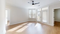 Located at 1155 Lavista Rd NE in Atlanta's vibrant 30324 corridor, this well-appointed 2-bedroom, 2-bathroom single-story home delivers a clean, modern aesthetic throughout. Light hardwood flooring flows seamlessly across the entire living area, reflecting abundant natural light and creating a warm, cohesive feel.

The open-concept living, dining, and kitchen area serves as the heart of the home. The kitchen is outfitted with warm, wood-toned cabinetry, white quartz countertops, a subway tile backsplash, and a full suite of stainless steel appliances including a gas range, built-in microwave, and French door refrigerator. A peninsula with pendant lighting provides both prep space and a casual dining option. Crown molding and a ceiling fan add refinement to the airy living area, which opens directly to a private patio through glass French doors.

Both bedrooms are generously sized, bathed in natural light from large windows, and equipped with ceiling fans and ample closet space. The primary bedroom connects to a dedicated bathroom. The bathrooms feature classic white subway tile surrounds, soaking tubs, and matte black fixtures for a contemporary touch. Additional conveniences include a dedicated laundry room, pantry, and utility room, completing this thoughtfully designed home.