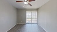 This 730 square foot single-story home in Dallas, TX offers a surprisingly spacious layout with 4 bedrooms and 2 bathrooms. The property features modern finishes throughout, creating a fresh and contemporary ambiance. Upon entry, you're greeted by light gray walls and stylish gray wood-look flooring that extends throughout the home.

The kitchen, while compact, is efficiently designed with white cabinetry, gray countertops, and black appliances. A fire extinguisher is prominently placed for safety. The bedrooms, including the generous 240 square foot primary bedroom, are bright and airy, featuring ceiling fans and large windows that allow ample natural light. Some rooms offer sliding glass doors, providing easy access to outdoor spaces.

Bathrooms are equipped with modern fixtures, including a shower-tub combination in at least one bathroom. The home's neutral color palette and clean lines create a blank canvas for personalization. Storage solutions include built-in closets with double doors.

Despite its modest square footage, the layout maximizes space usage, making it feel larger than its actual size. The property's design emphasizes functionality and comfort, ideal for those seeking a low-maintenance yet comfortable living space in the heart of Dallas.